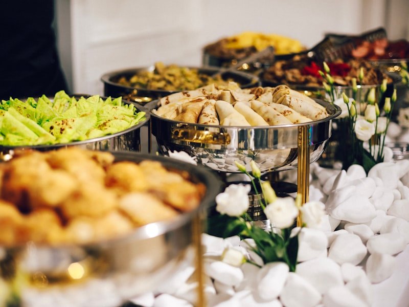 Catered buffet spread with hot stations and floral table accents at an Ottawa event