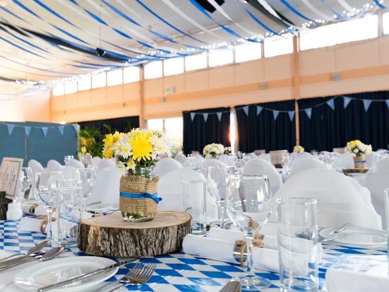 Wedding reception table setting with floral centerpiece and place settings