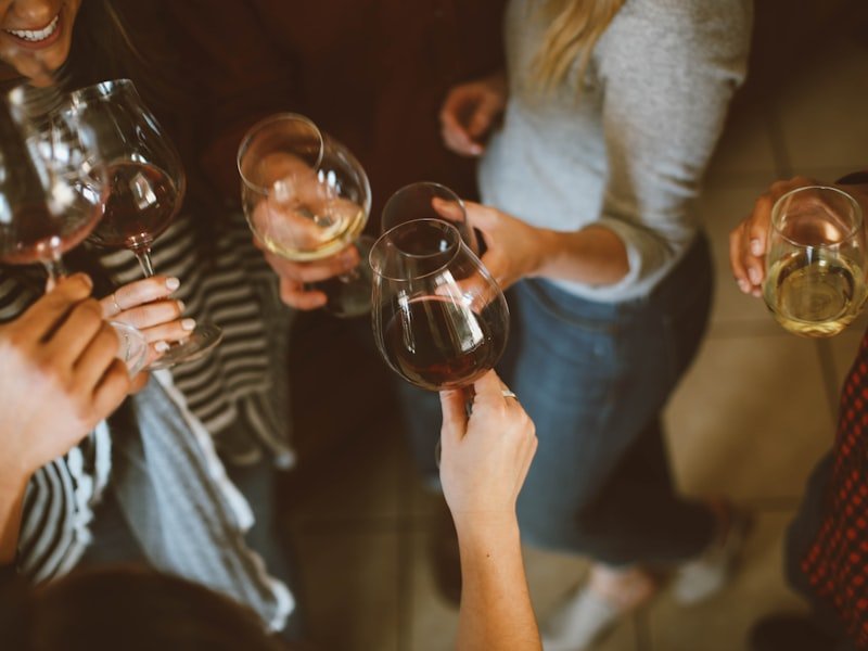 Cocktail reception guests clinking wine glasses at an Ottawa event