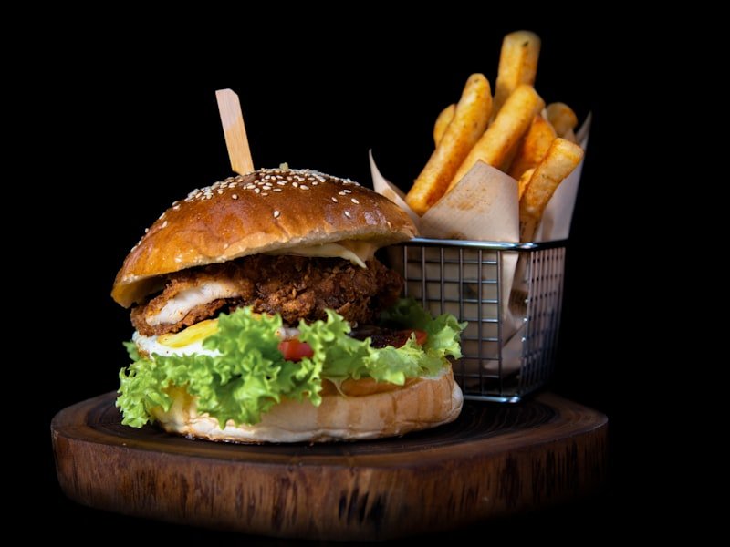 Late-night smashburger and golden fries on a wood serving board